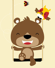 funny little bear cartoon playing swing with its friends