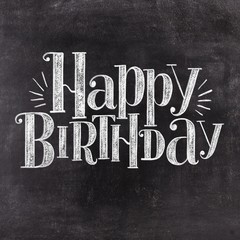 Hand lettering Happy Birthday on retro black chalkboard background. Vintage greeting card design. © Ann Lou