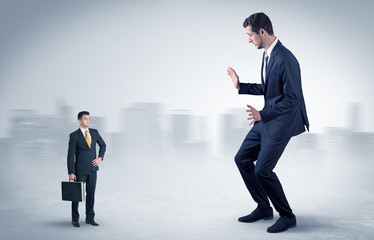 Giant businessman being afraid of small serious executor with suitcase
