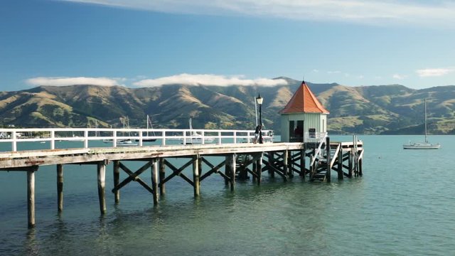 pier in the bay, jetty in akaroa new zealand, popular travel destination, scenic landscape view