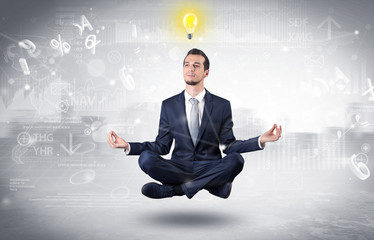 Businessman meditates with enlightenment data reports and financial concept
