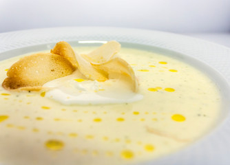 well-done thin slices of croutons in a creamy soup mashed butter in a white plate in a luxurious restaurant