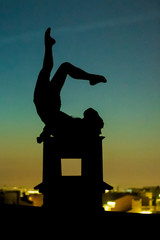 Acrobat on the roof at night
