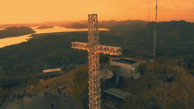 Mount Tapyas with large Christian religious cross at amazing sunset time in Coron city. 15 February - 2019. Busuanga island, Palawan, Philippines.