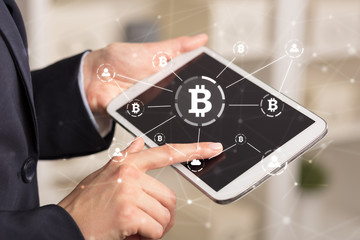 Business woman using tablet with cryptocurrency bitcoin link network and online concept
