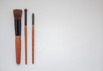 wooden make-up brushes isolated on white background
