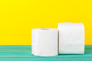 Toilet paper stacks  on bright yellow background