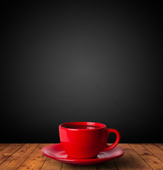 Cup of drink on wooden table with dark background
