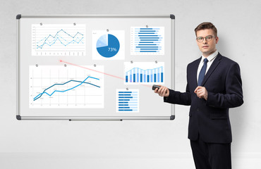Handsome businessman presenting report on white board with laser pointer 
