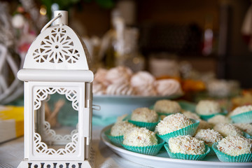 ornamentation with a metal lantern and sweets in a platter, background bokeh