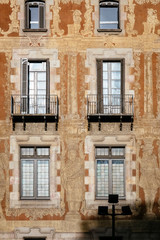 Fototapeta na wymiar Old facade Building Windows with balcony Art ornate painting Historical Architecture detail Barcelona Spain