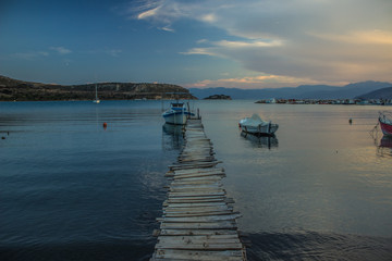 Fototapeta premium morning twilight coast line of sea bay outdoor natural environment with poor wooden bay and fishing boat