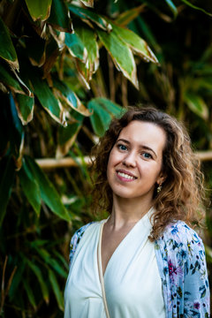 Fashion portrait of a beautiful cute woman in a bamboo forest at a natural park