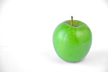 green apple lies on a white table