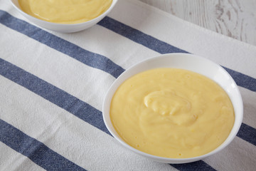 Homemade vanilla custard pudding in white bowls, low angle view. Close-up.
