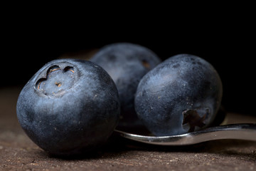 Blueberries macro studio shot on wooden top