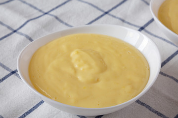 Homemade vanilla custard pudding in a bowl, side view. Close-up.