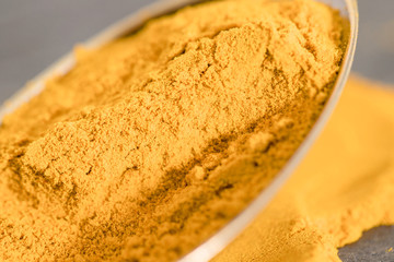 Turmeric on spoon macro studio shot