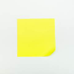 Yellow paper stick note on a white background