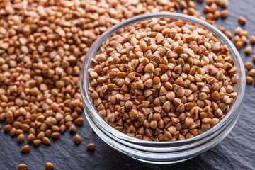 Grain buckwheat on a dark stone background