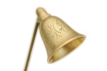 Close up image of brass candle snuffer