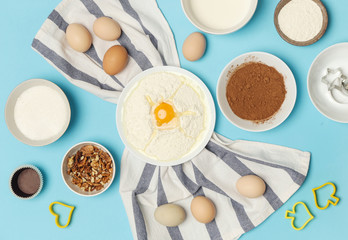 Creating a recipe, Top view of the basic baking ingredients on the blue table, cooking concept
