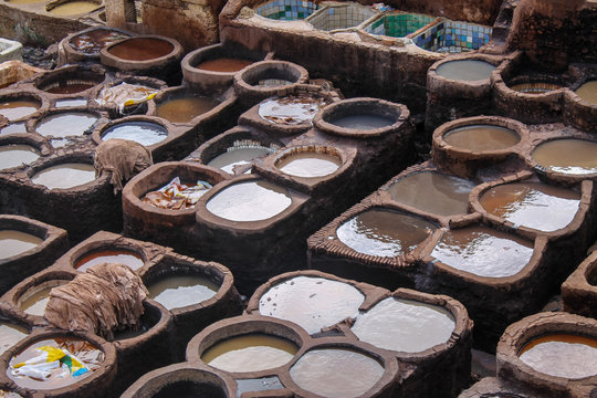 FEZ, MOROCCO - November 1, 2012: Leather dying in a traditional tannery in the city Fez, Morocco
