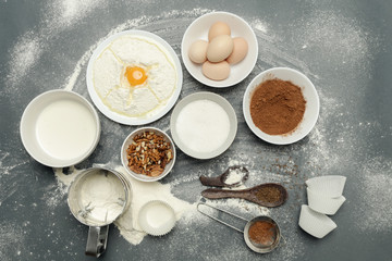 Creating a recipe, Top view of the basic baking ingredients and kitchen utensils on the dark background, cooking concept