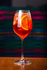 Aperol spritz cocktail in glass on wooden table in the interior of the restaurant.
