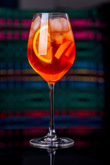 Aperol spritz cocktail in glass on black reflection table in the interior of the restaurant.