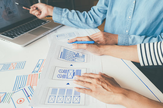 Creative Web Designer planning application and developing template layout, framework for mobile phone. User experience (UX) concept.