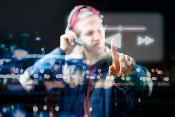 atrractive male use futuristic device to listen to music b