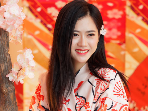 Portrait Of Attractive Chinese Woman Wearing Traditional Japanese Kimono, Smiling At Camera, Oriental Beauty.