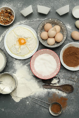 Creating a recipe, Top view of the basic baking ingredients and kitchen utensils on the dark background, cooking concept