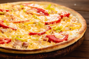 Appetizing pizza on a wooden background