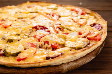 Appetizing pizza on a wooden background