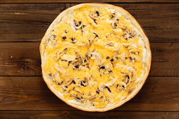 Appetizing pizza on a wooden background