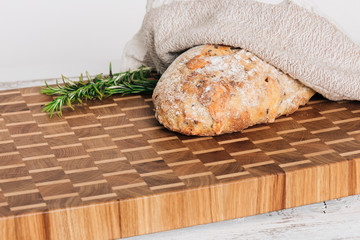 Loaf of bread on wooden background, food closeup