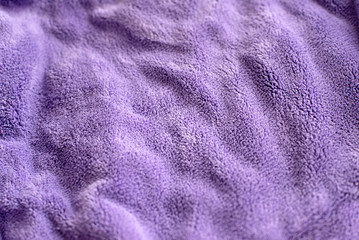 Fototapeta na wymiar Lilac delicate soft background of fur plush smooth fabric. Texture of purple soft fleecy blanket textile