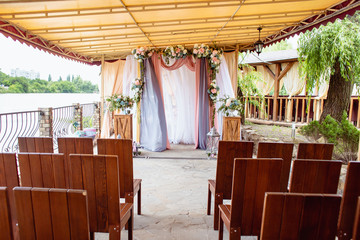 Wedding decoration ceremony. Arch of flowers on the summer area of the restaurant