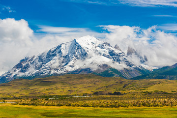 Fototapeta premium Torres del Paine peaks coming from clouds