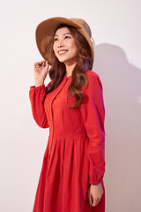 Beautiful young lady in straw hat over white background