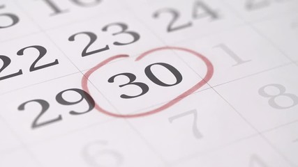 Marking the thirtieth 30 day of a month in the calendar with a red marker