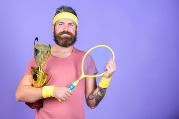 Tennis player win championship. Athlete hold tennis racket and golden goblet. Win tennis game. Man bearded hipster wear sport outfit. Success and achievement. Tennis match winner. Achieved top