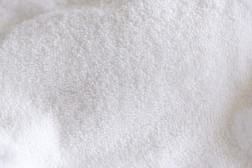 Fototapeta na wymiar White delicate soft background of fur plush smooth fabric. Clean white tarry towel blanket textile