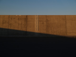 Concrete wall and white ladder