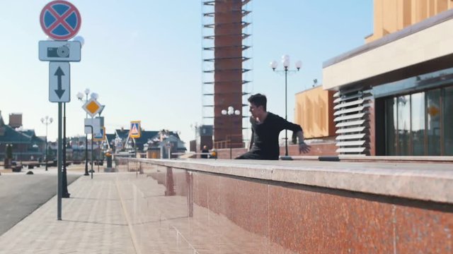 A young man overcoming obstacles on the urban streets