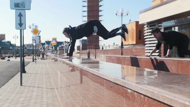 Three young men overcoming obstacles on the urban streets