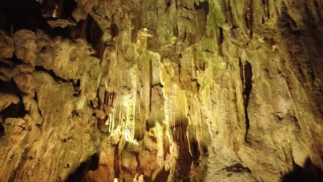 Close sharp stalactites stalagmites rocks Surprise cave surface. Ancient deep underground grotto mystical place natural void in ground. Untouched texture. Fossil geology. Vieynam sight. Dolly gimbal