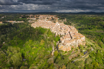 Fototapeta na wymiar Fly above old city in Tuscany in Italy in spring sunset.